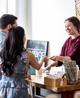 a young couple makes a purchase inside a store