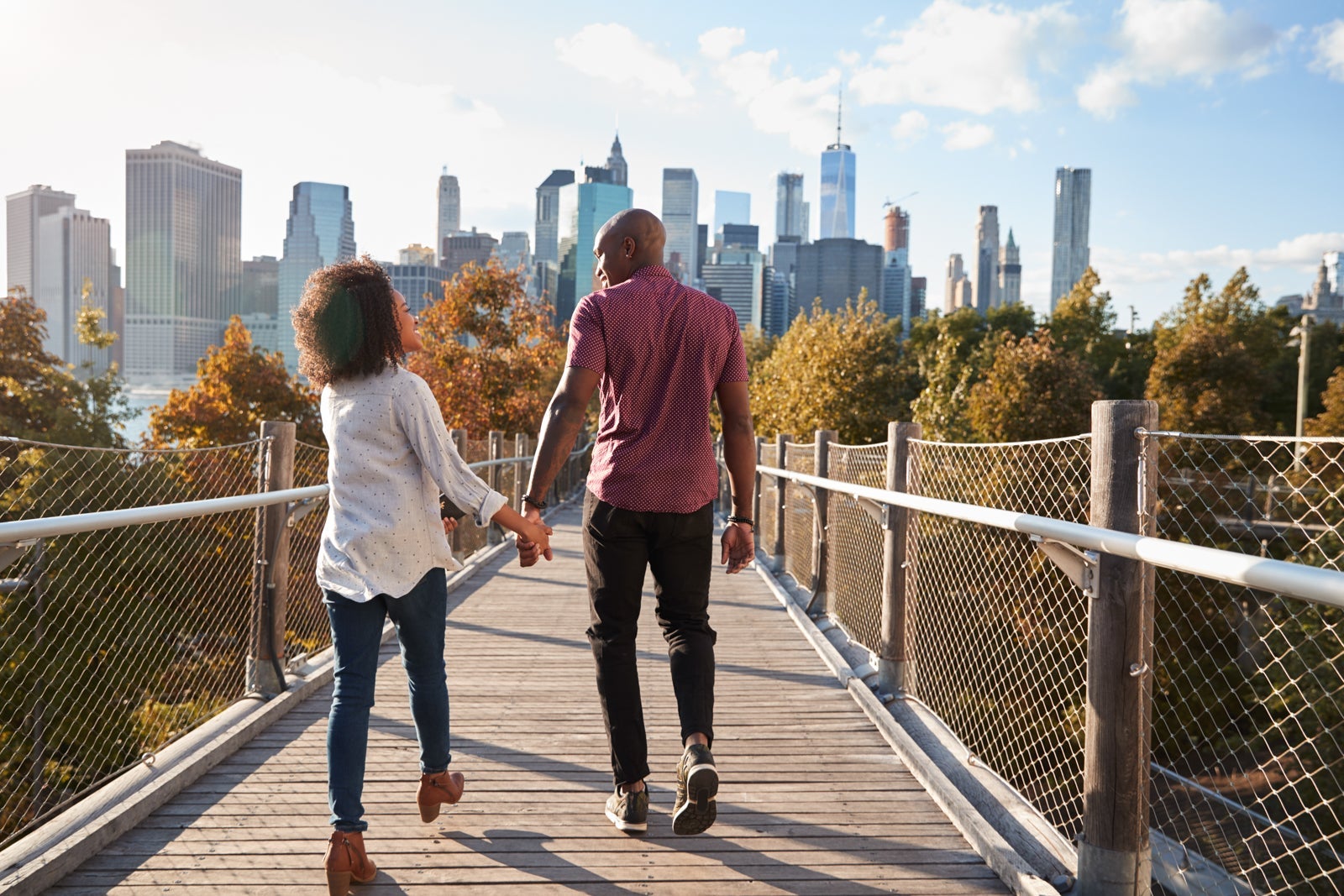 Best places to travel in September 2025 Couple Visiting New York With Manhattan Skyline In Background