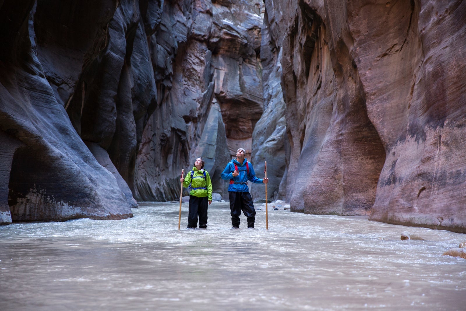 A couple hiking in the Narrows at Zion National Park