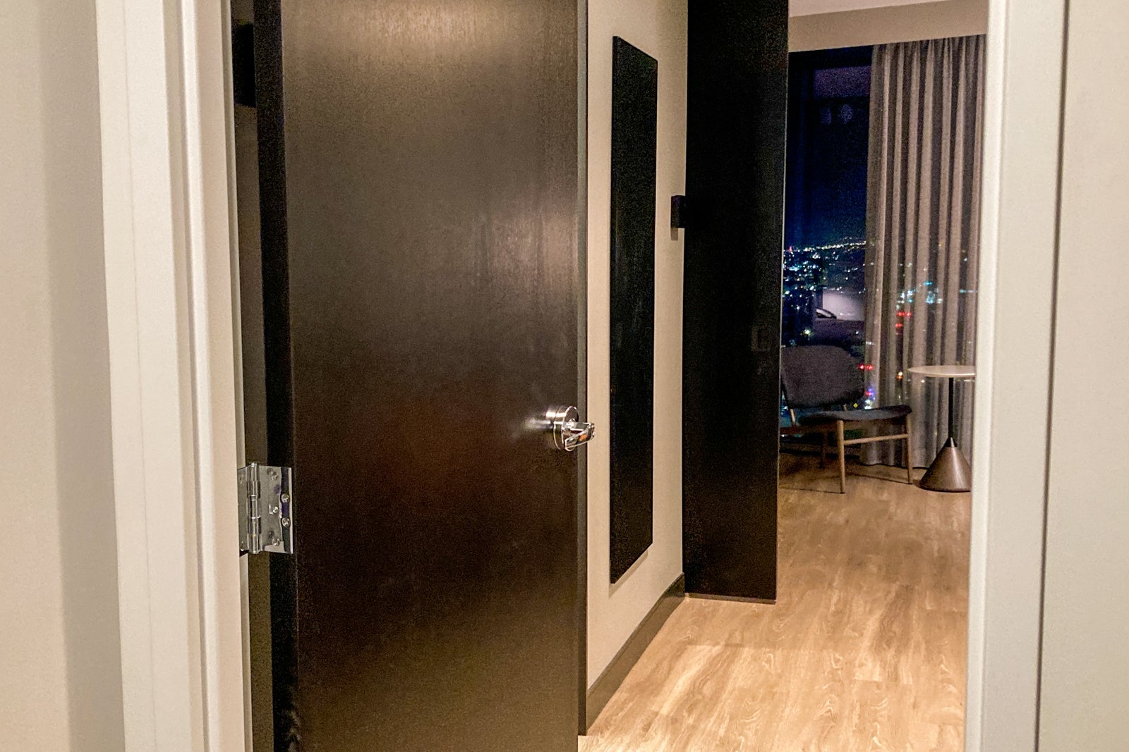 looking toward the bedroom from a hotel room entry