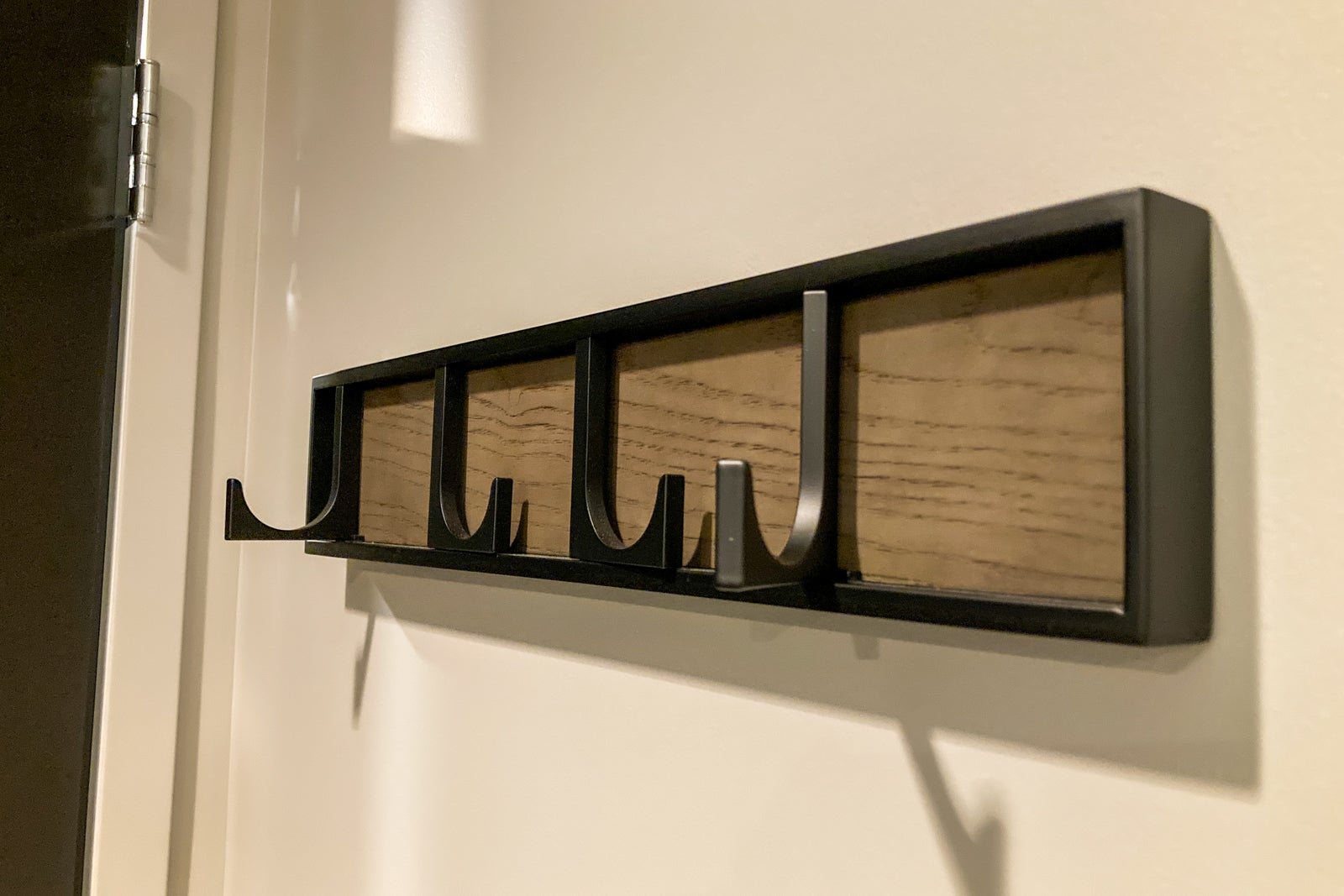 collapsable coat hooks on a wall