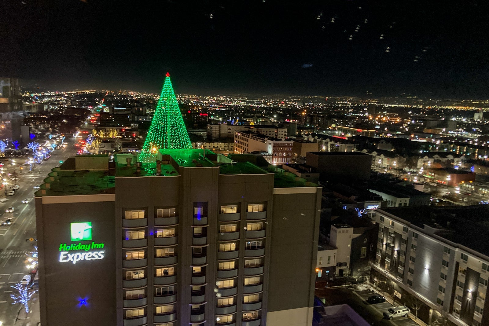 holiday lights are seen in a city at night