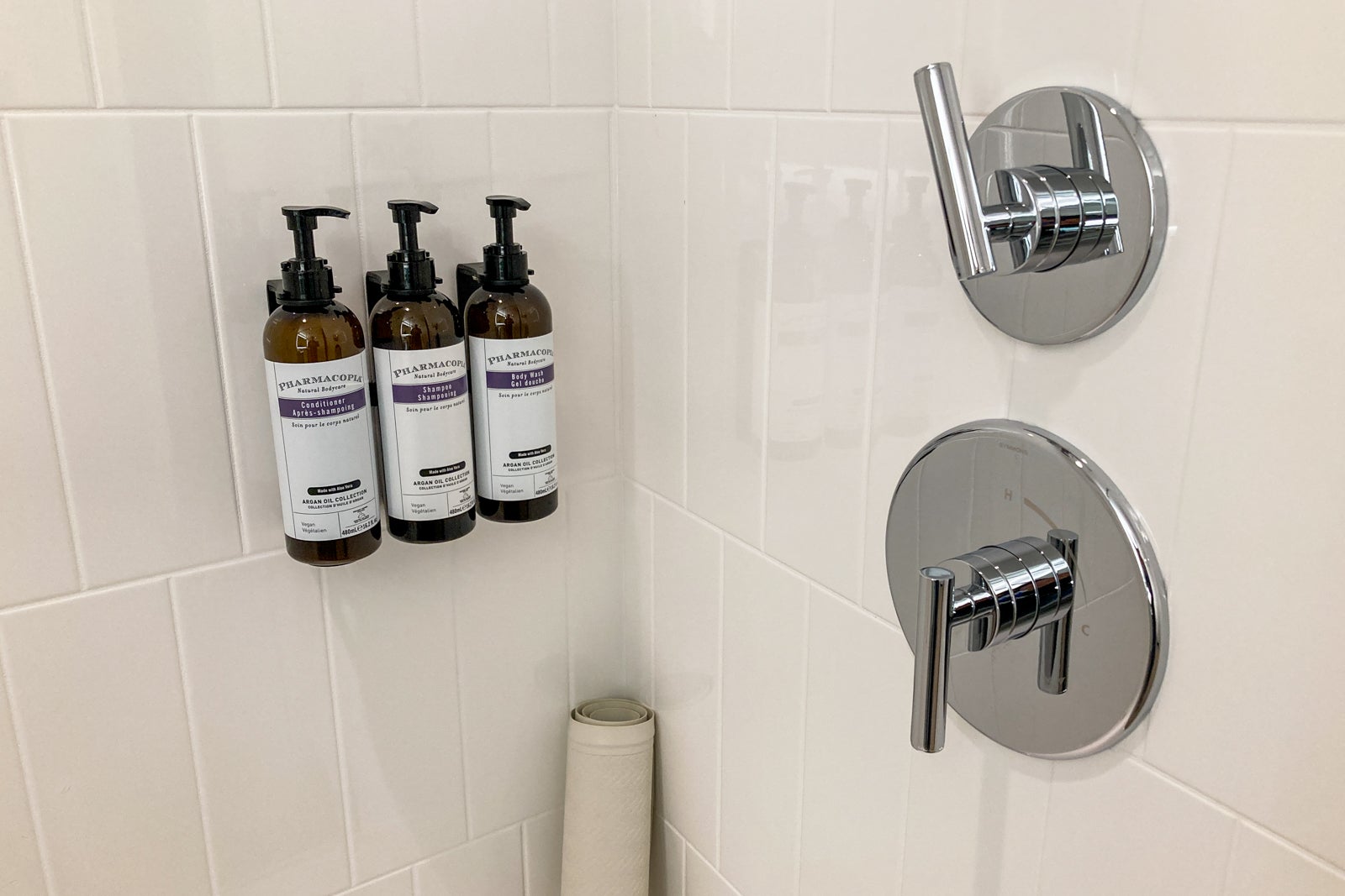 control knobs and pump bottles in a hotel shower