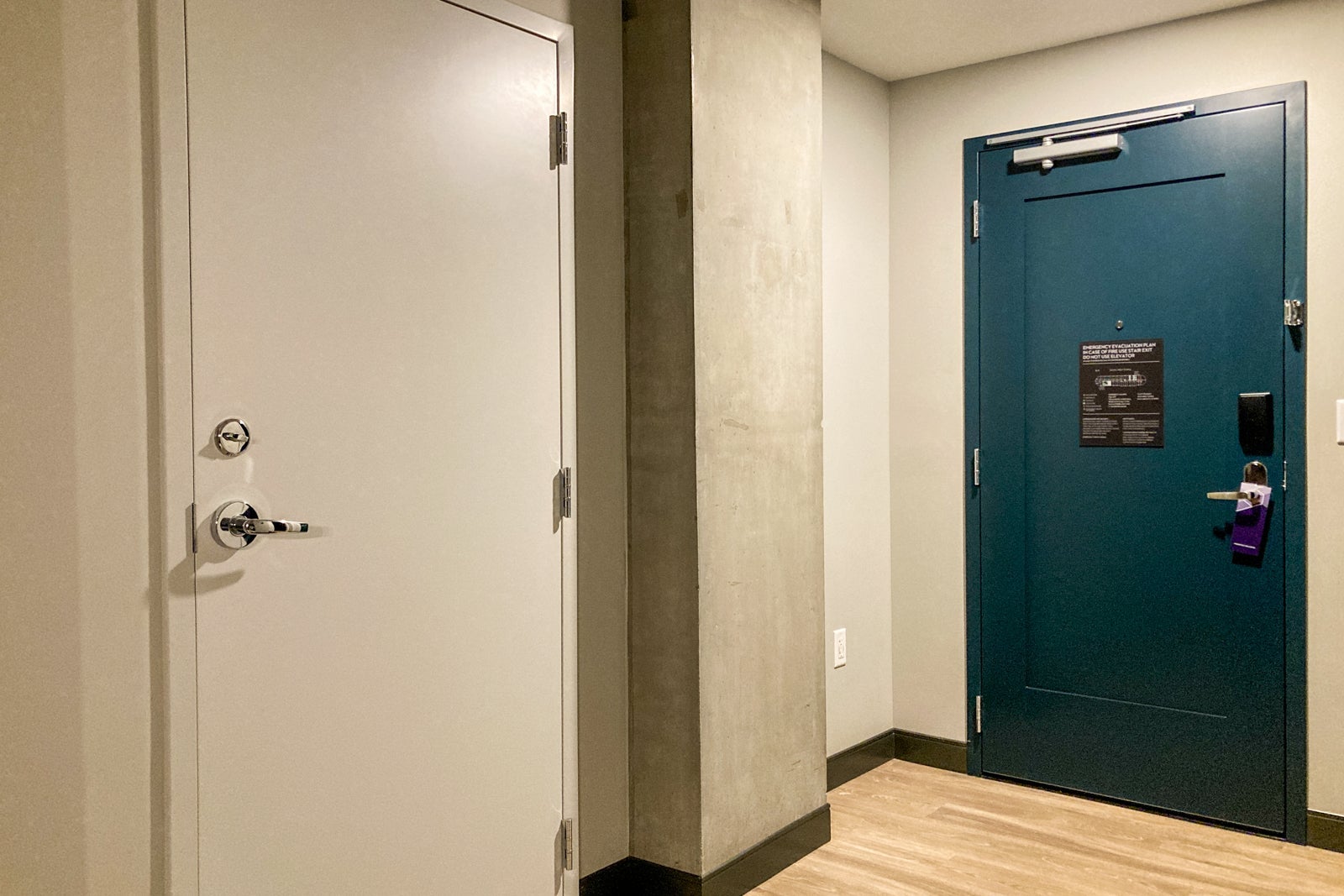 a deep green hotel room door as seen from the inside