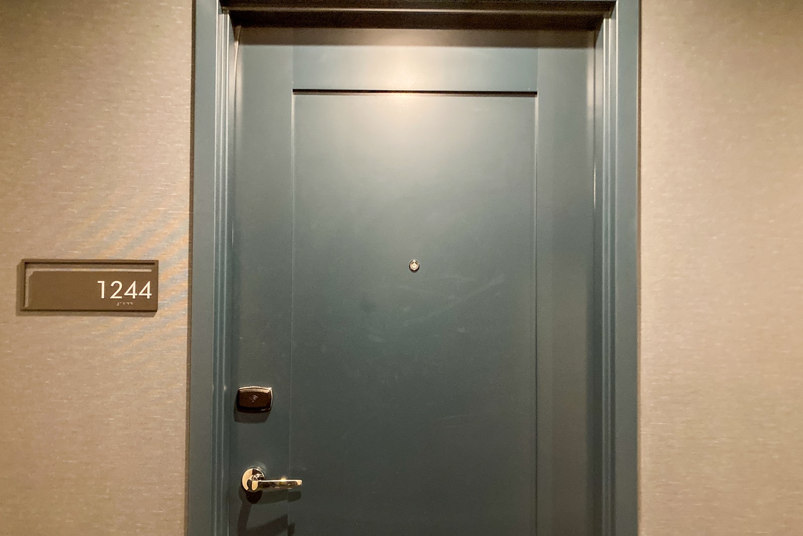 a deep green hotel room door
