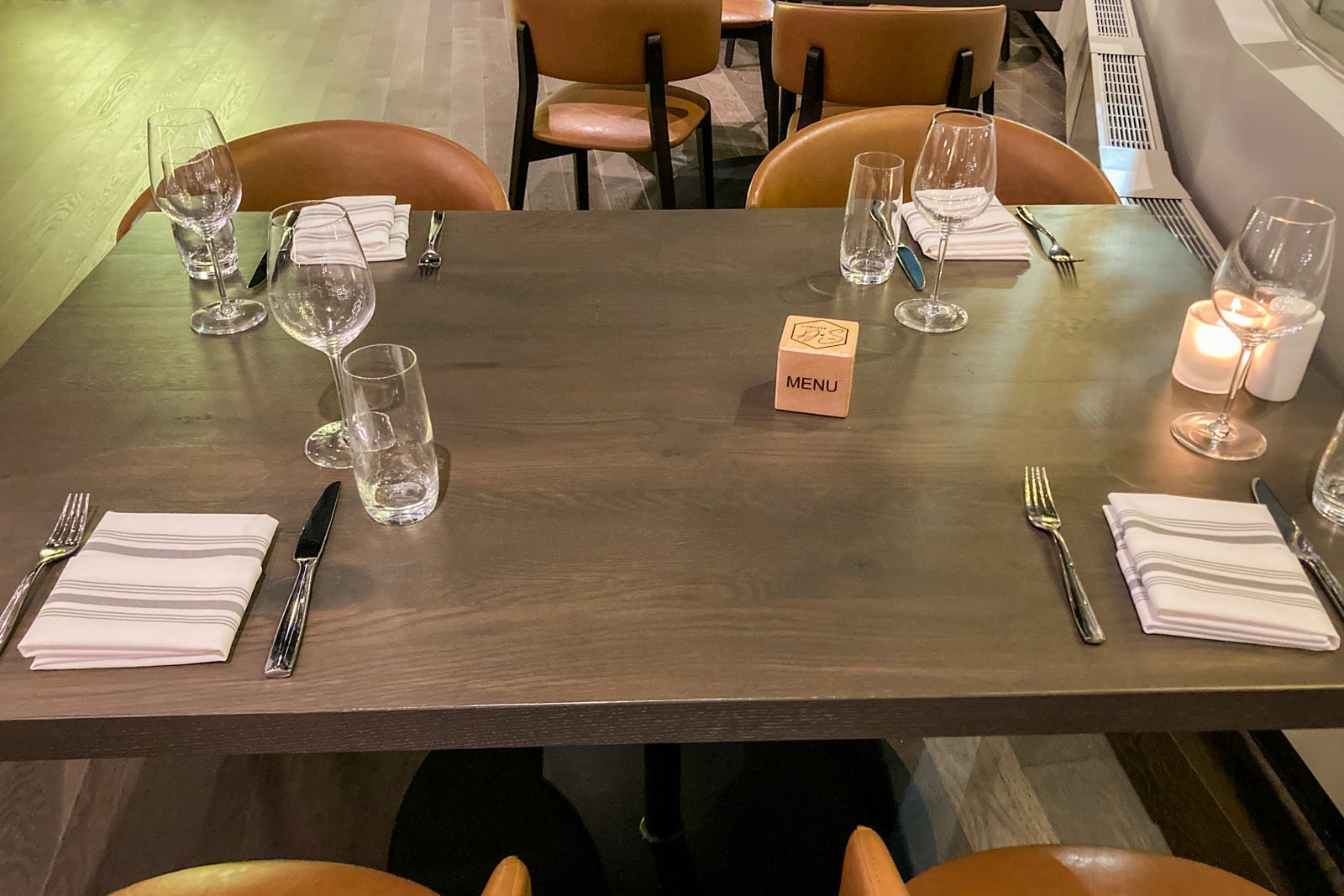 a four-person table with place settings in a restaurant