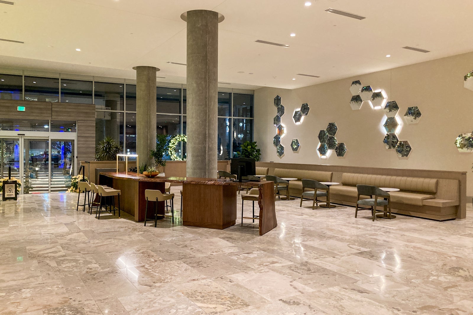 an open hotel lobby area with work desks in the corner