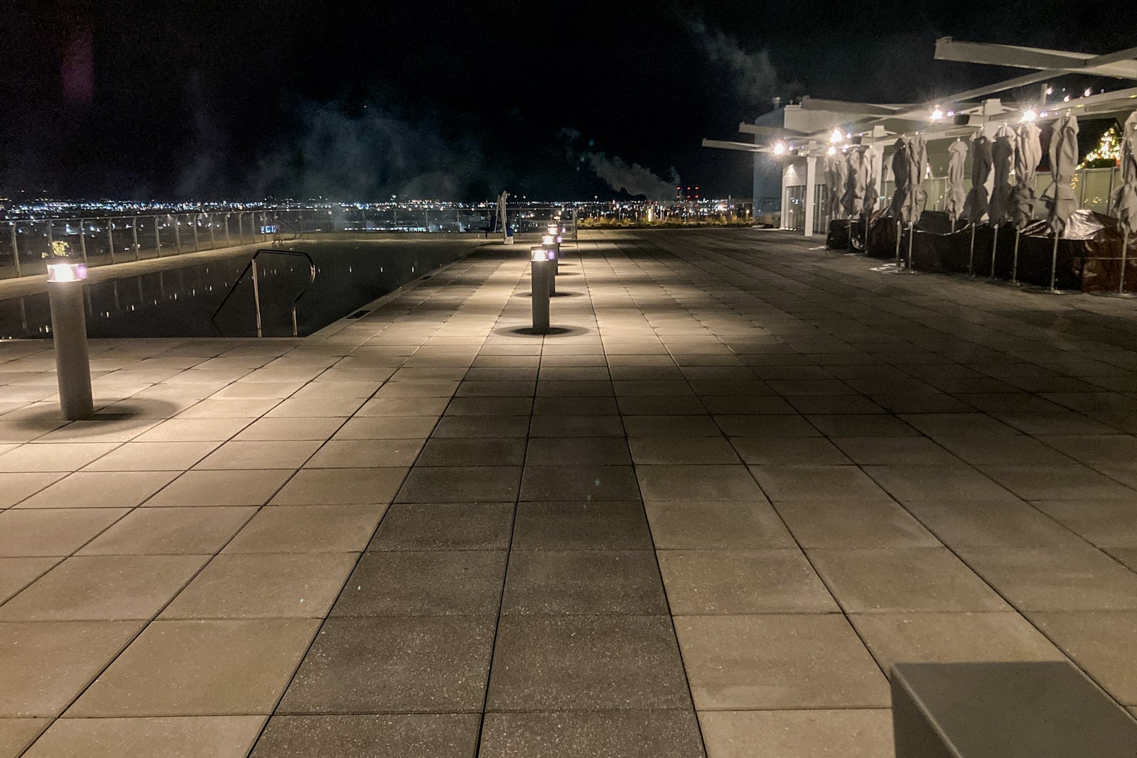 steam comes off an outdoor pool at night