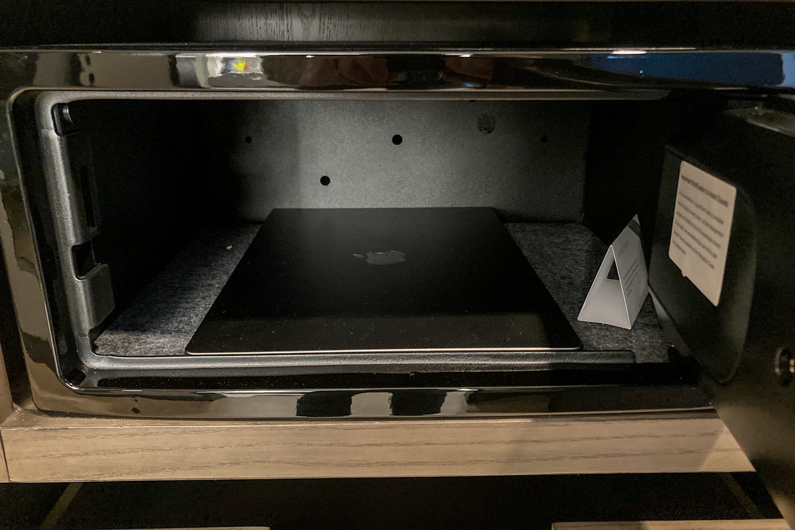 a laptop sits inside a hotel room safe
