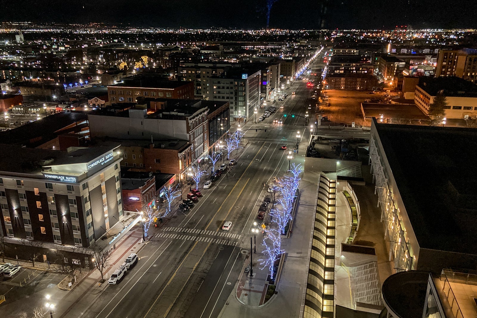 nighttime views over a city with mountains beyond