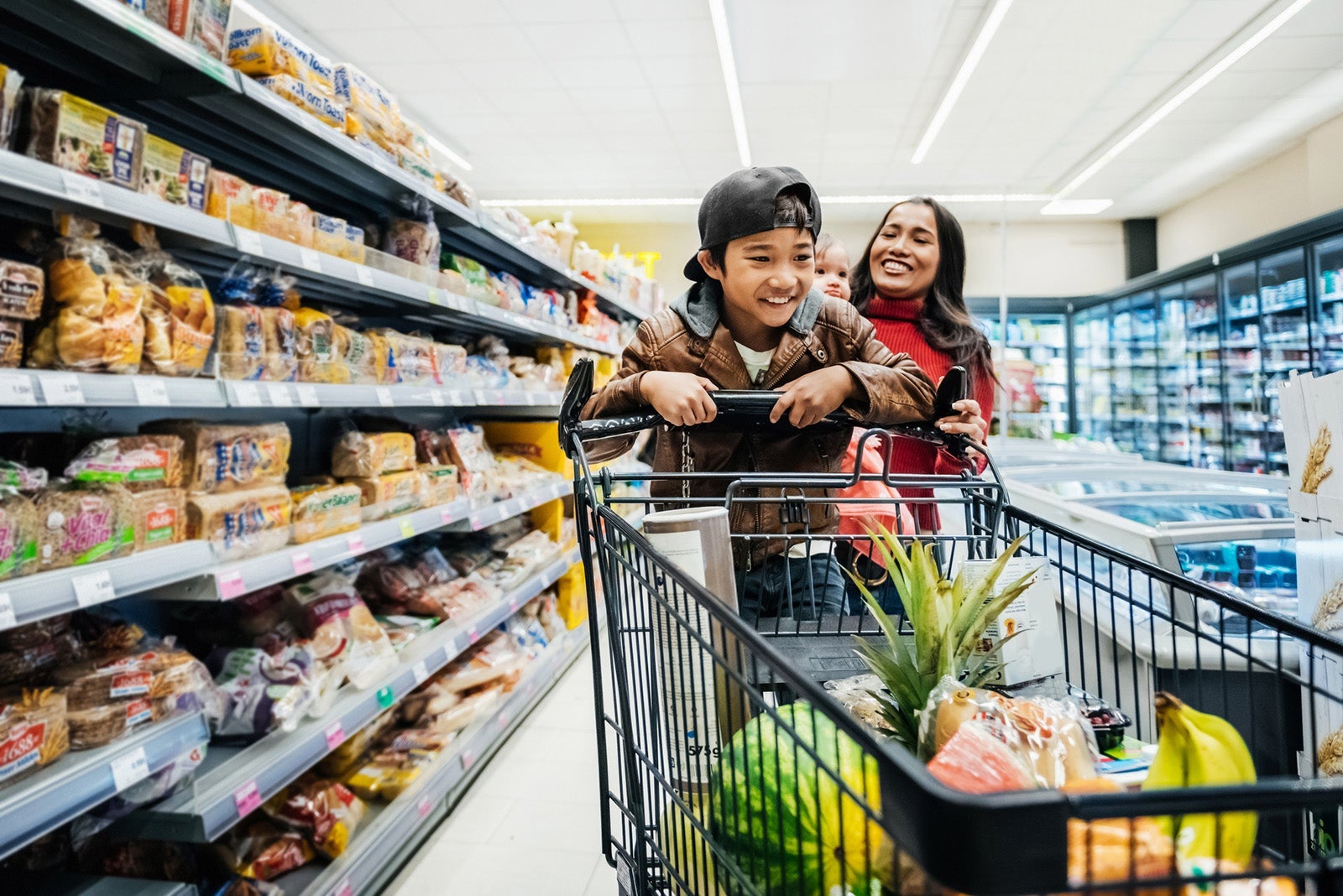 Mom and son shopping in grocery store