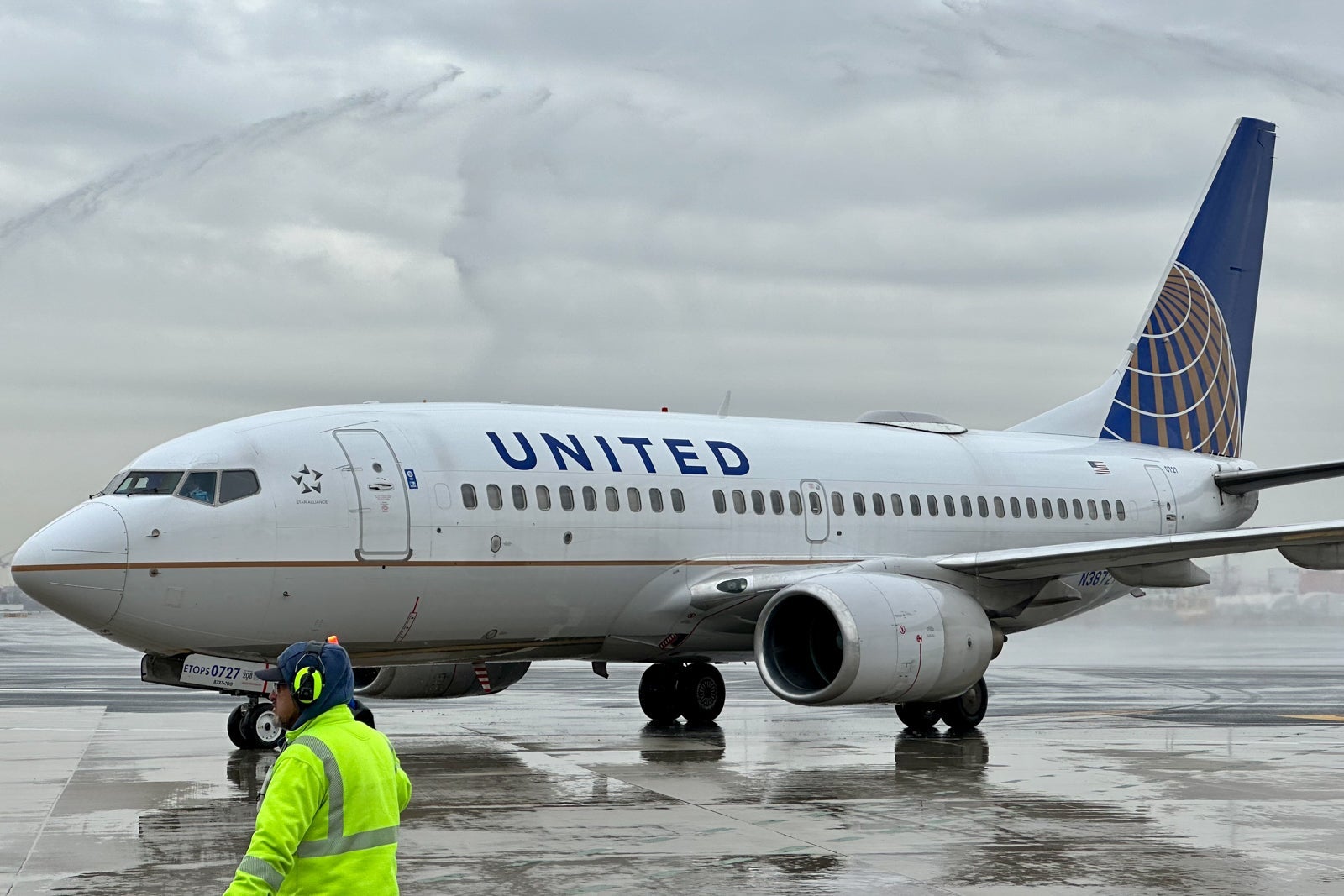 United plane on wet pavement