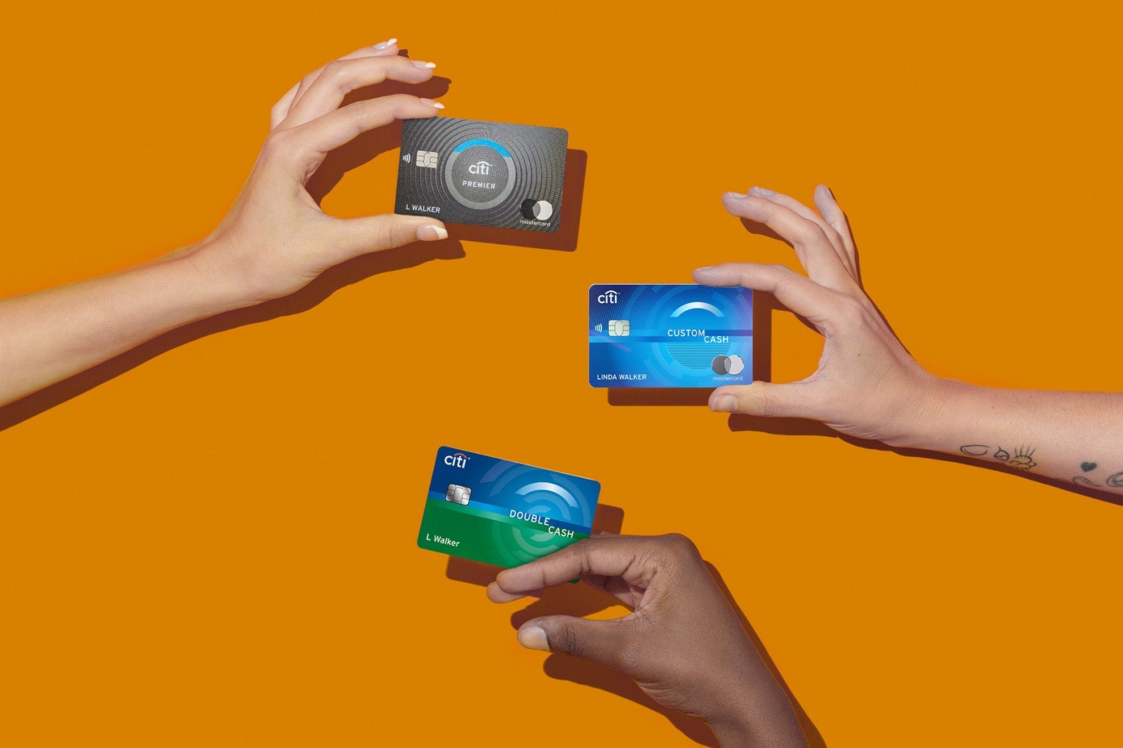 hands hold multiple credit cards from Citi