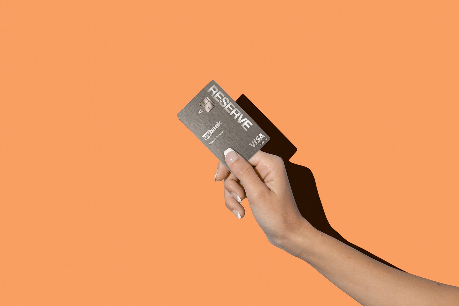 a hand holds a US Bank reserve Visa credit card