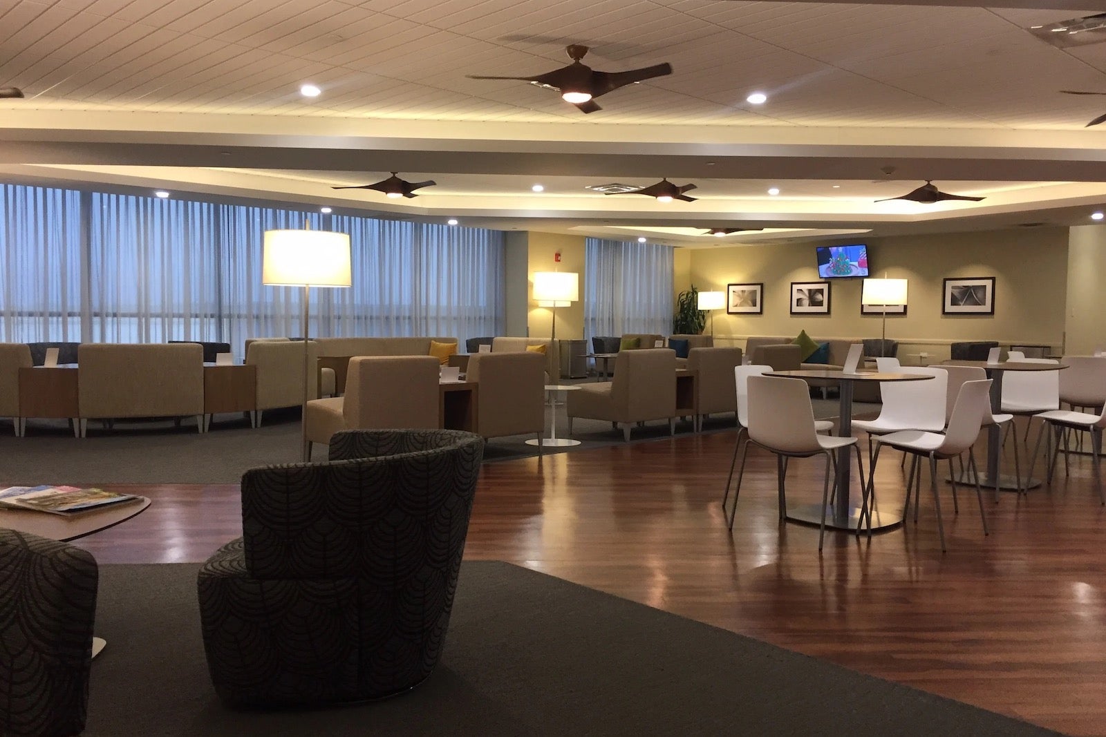 an open area with multiple seating options in an airport lounge