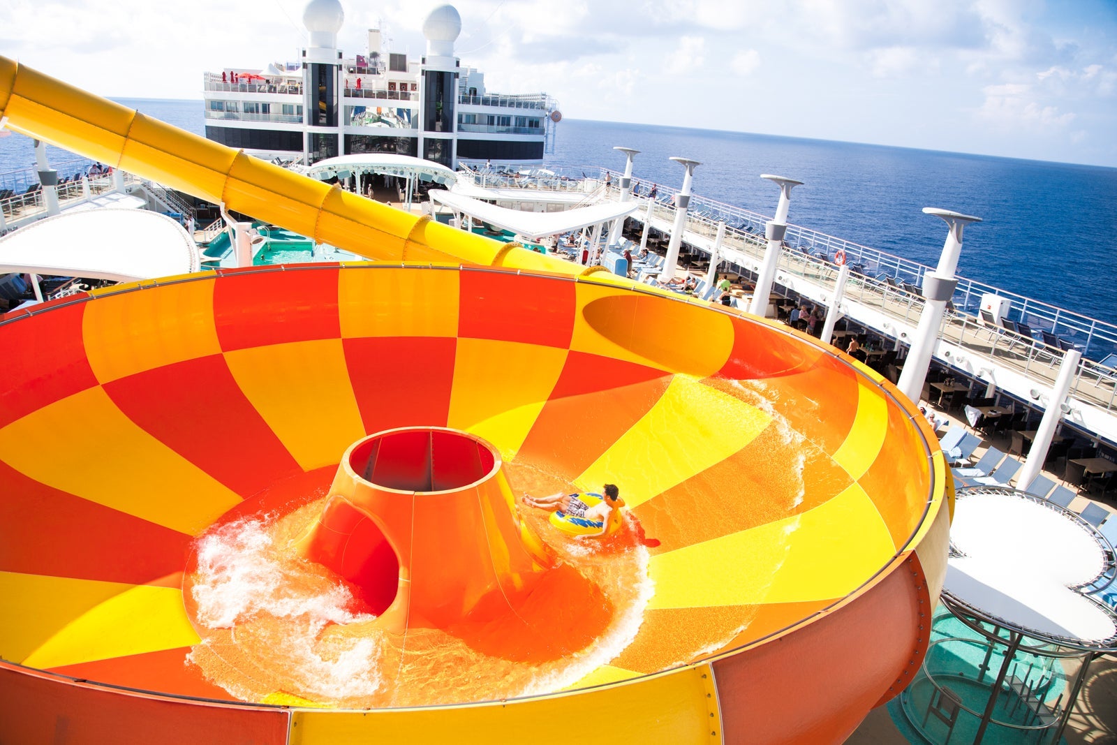 A cruise passenger slides down the water slide Epic Plunge