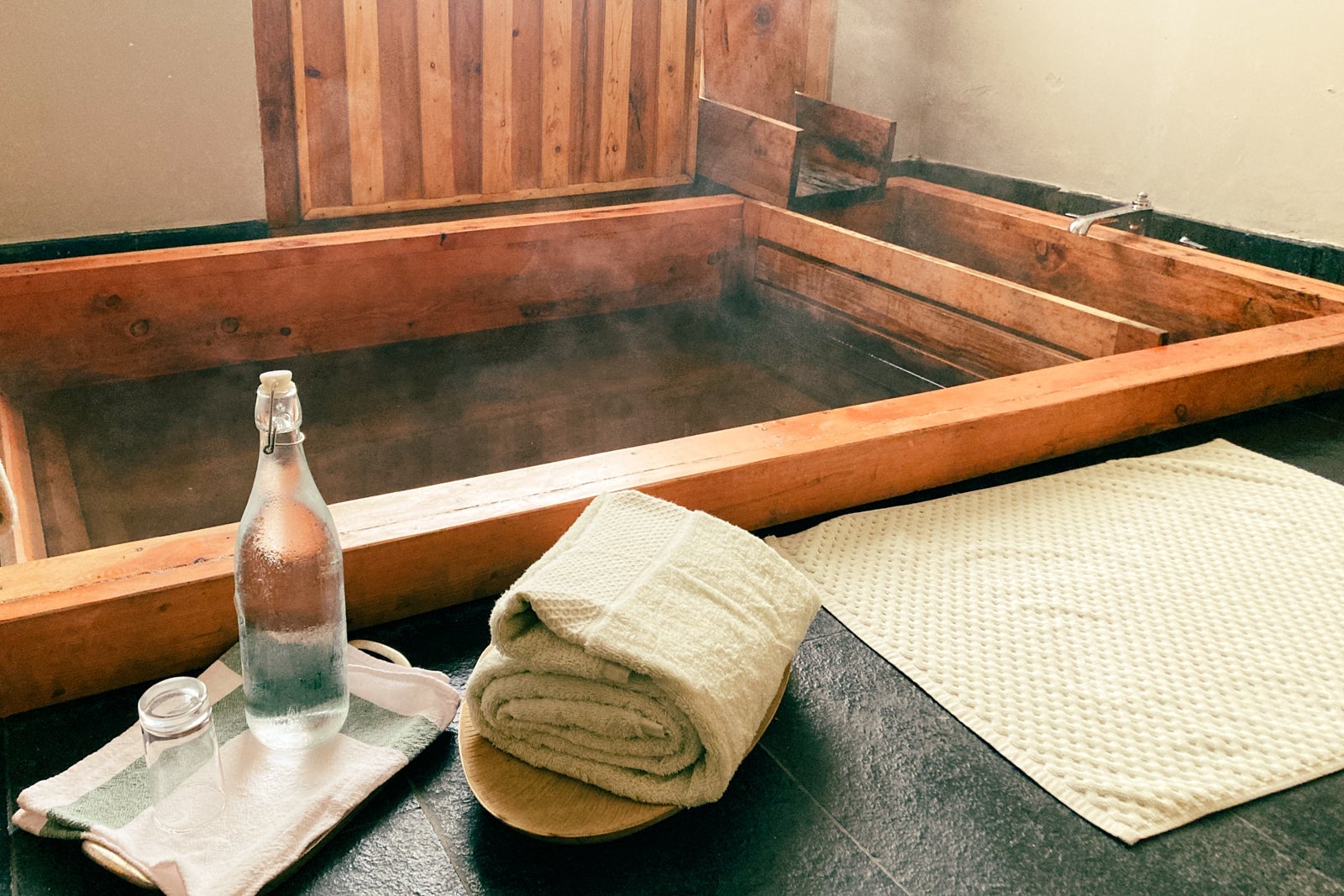 a traditional hot bath is ready, with towels and bottled water nearby
