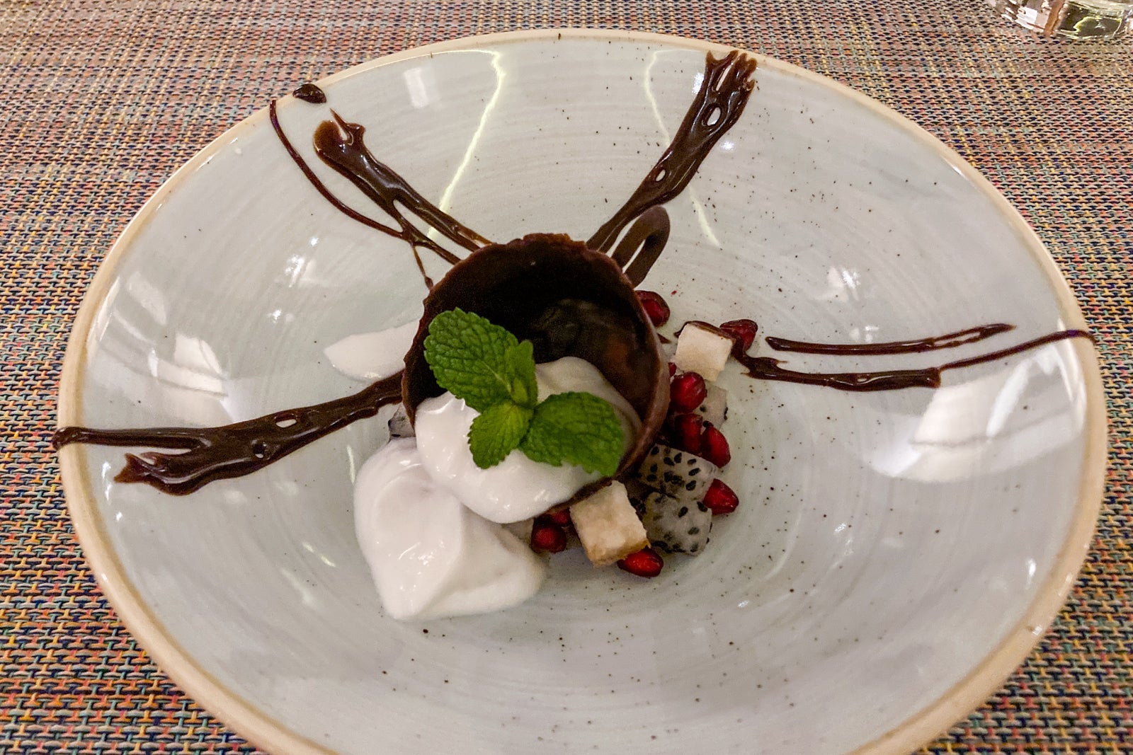 overhead image of a cream dessert inside a chocolate bowl