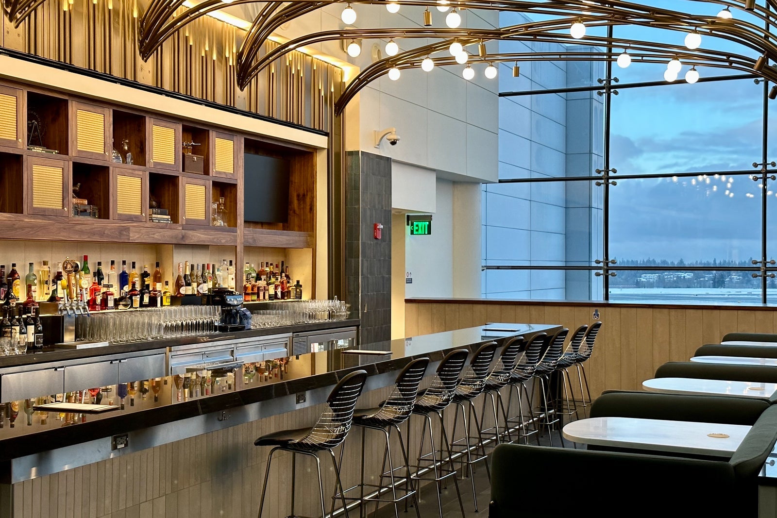 bar stools line a bar at an airport lounge
