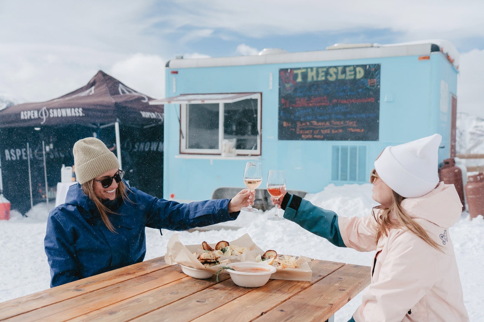 Skiers toast over an outdoor meal at the Limelight Hotel in Aspen