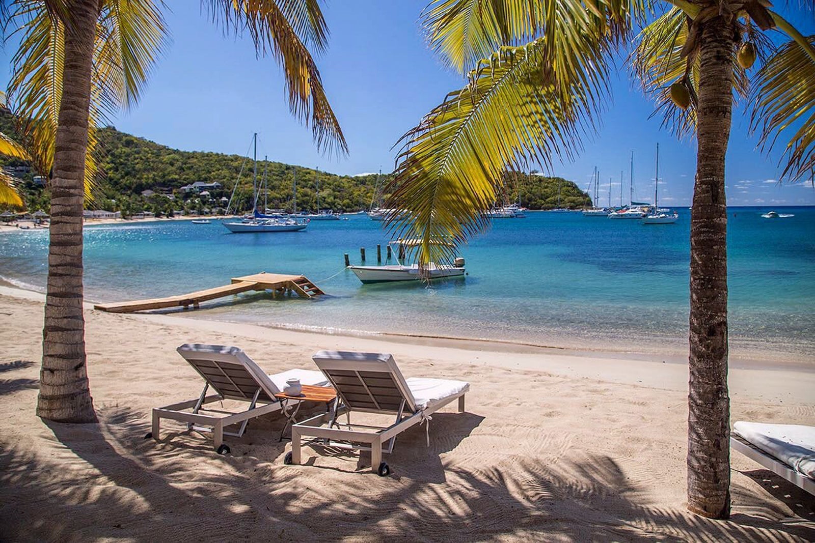 Two lounge chairs on the beach at The Inn at English Harbour