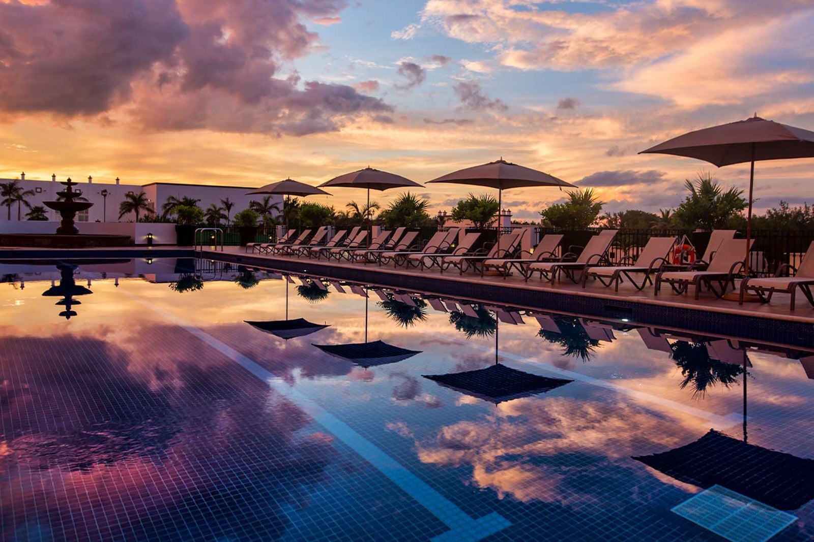 Pool at dusk at Grand Residences Riviera Cancun, a Registry Collection Hotel