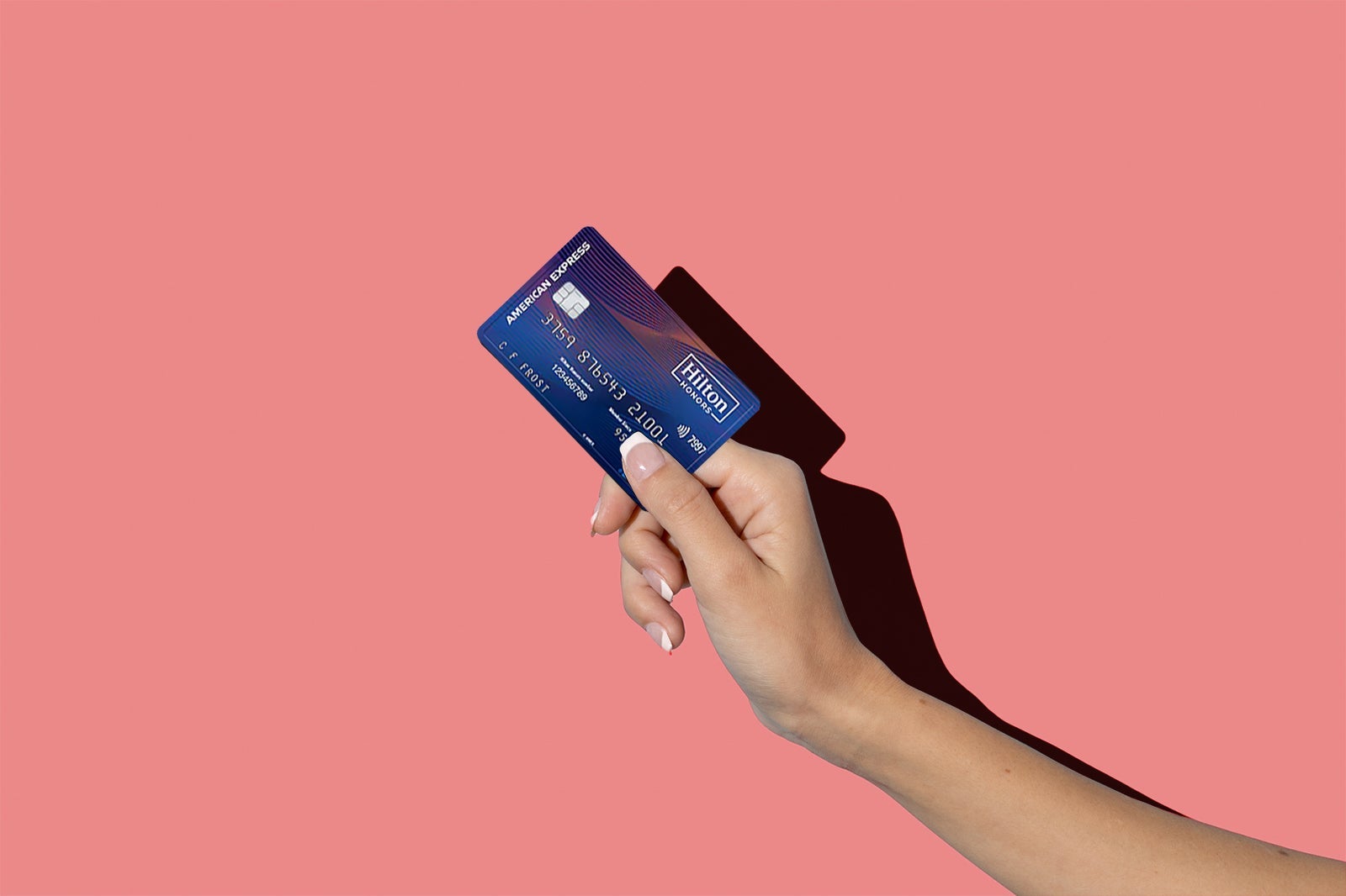 a hand holds a credit card