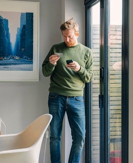 Man using a phone with a credit card