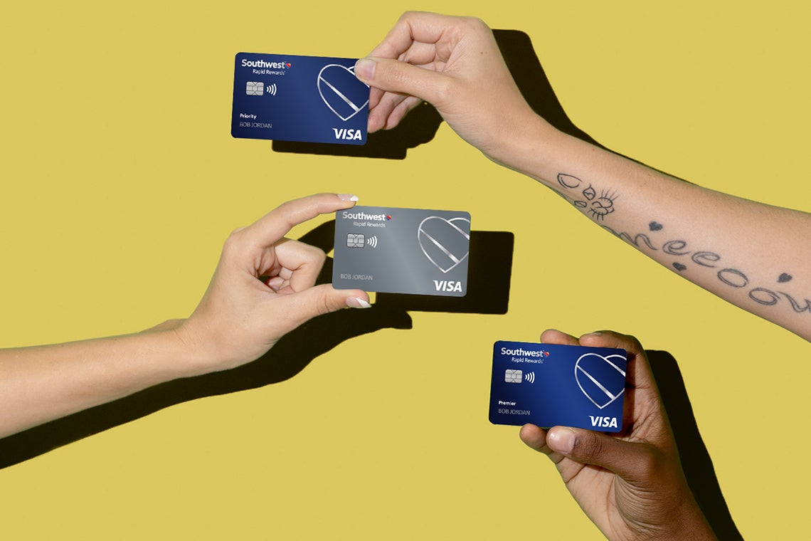 hands hold multiple Southwest Airlines credit cards