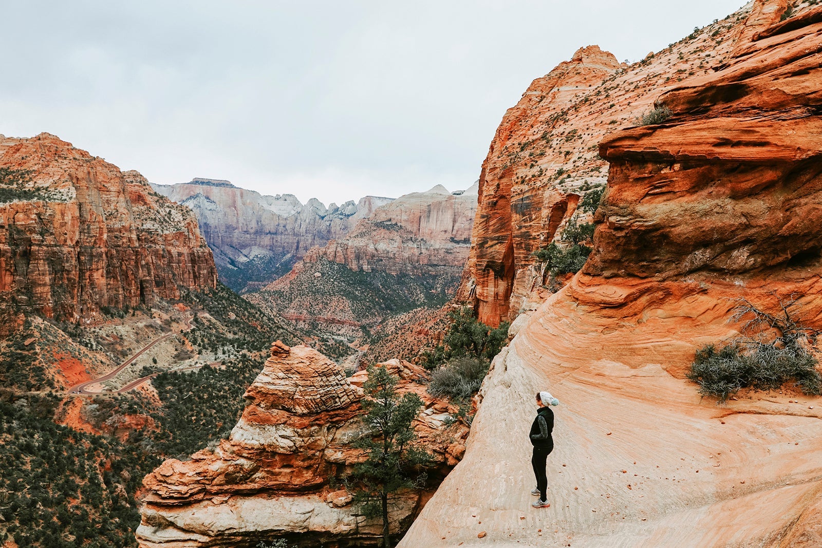 Woman standing on a cliff in Zion National Park