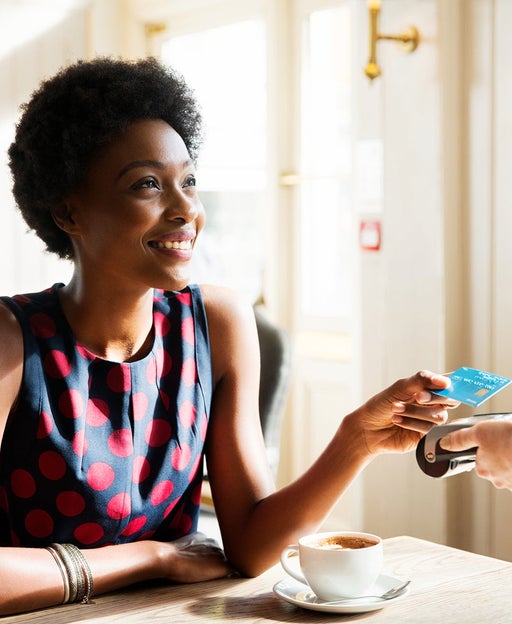 woman paying at cafe