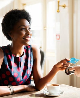woman paying at cafe