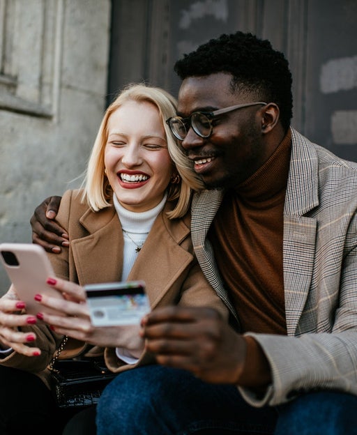 2 friends look at a smartphone together