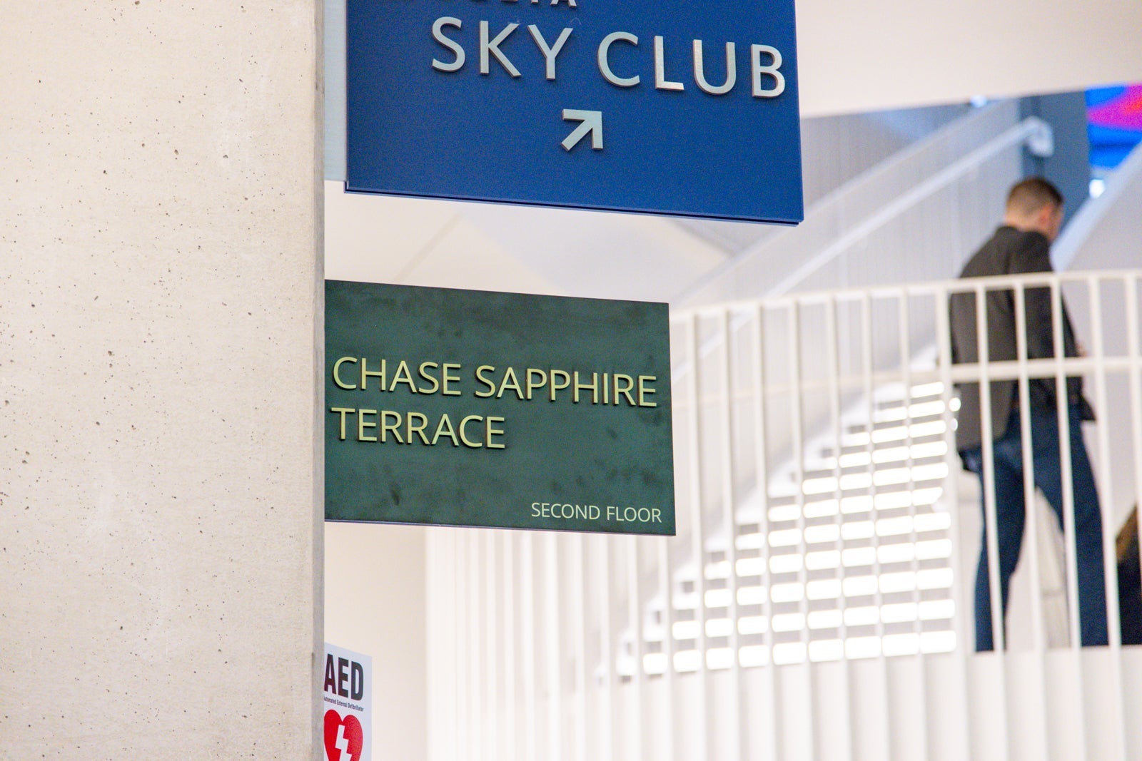 stairs and signs toward airport lounges