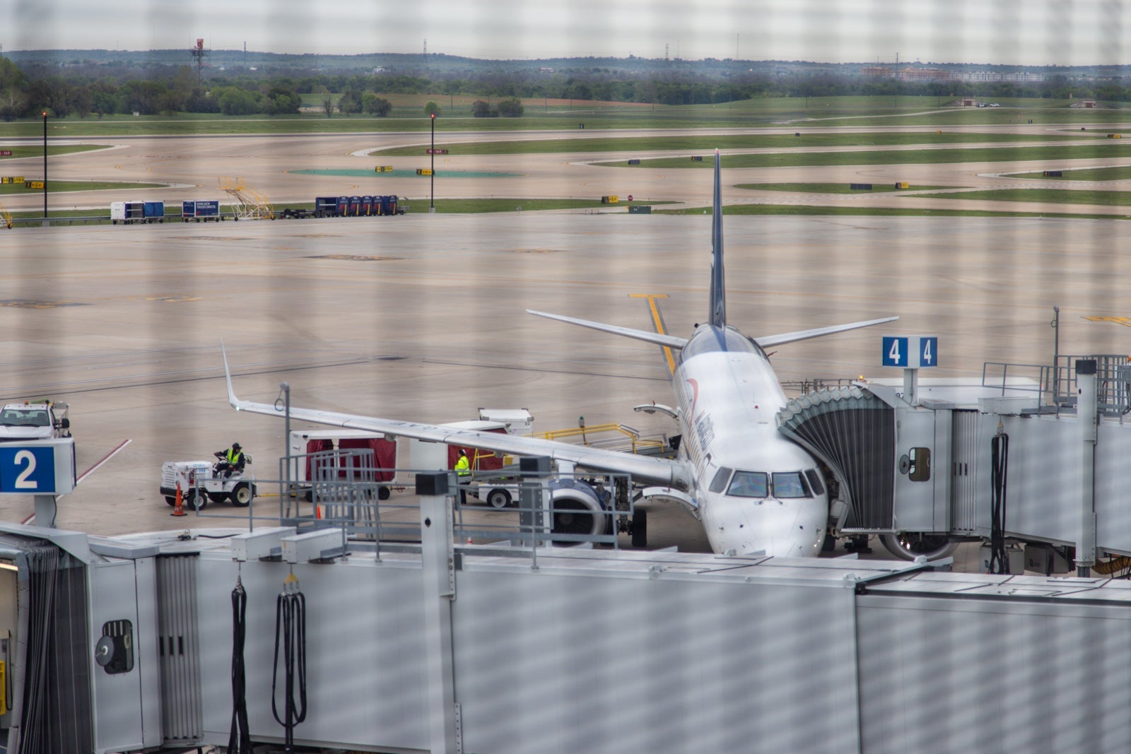 a Hawaiian Airlines plane is visible through a screen