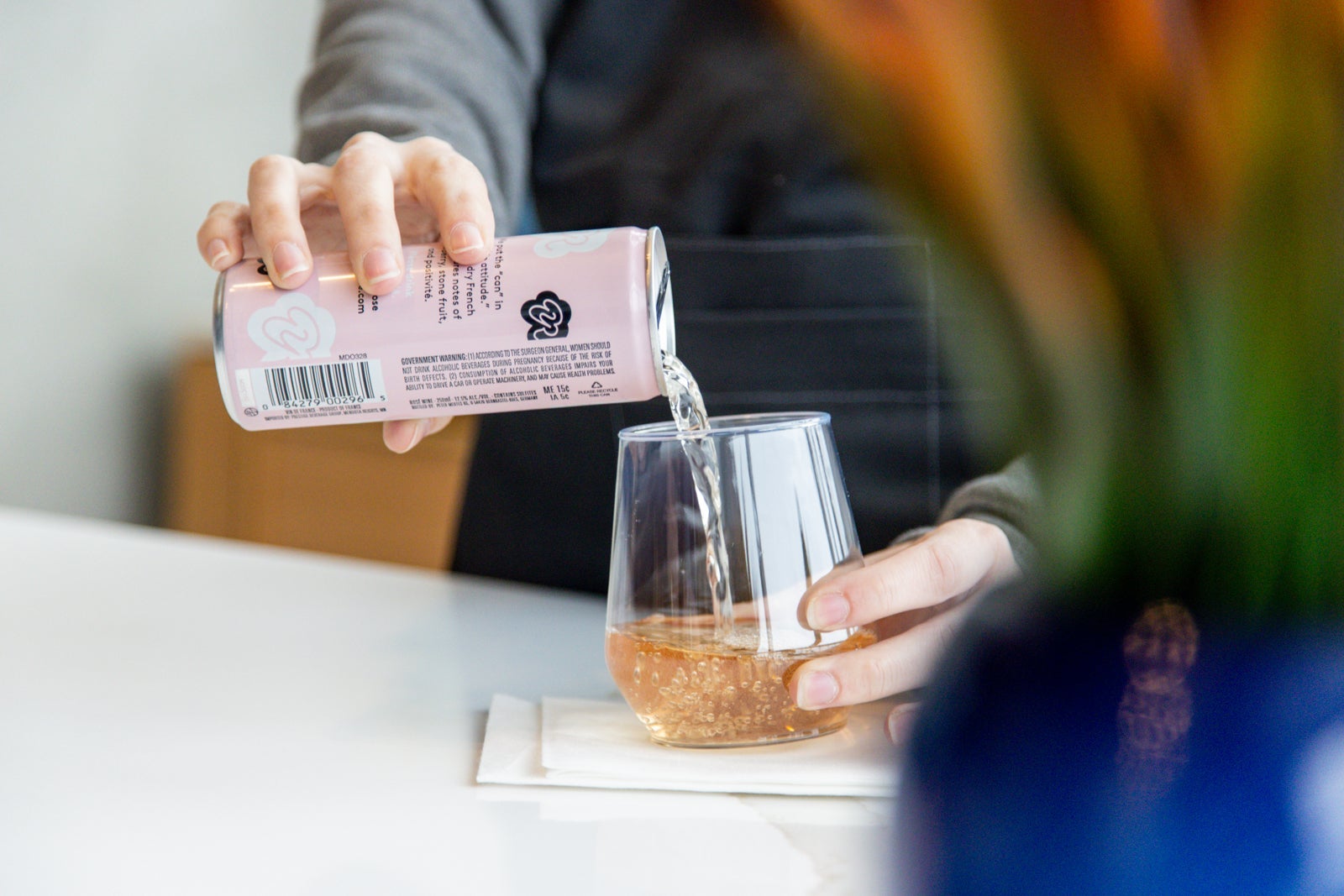 an unseen person pours a drink