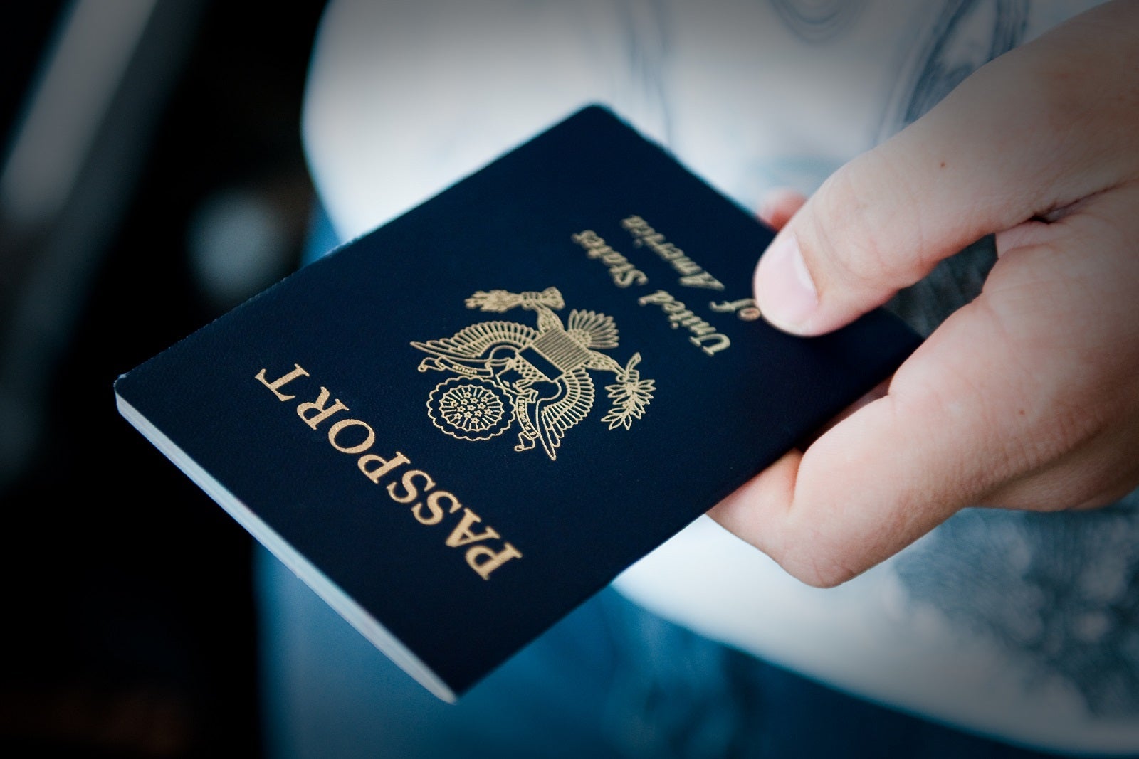 A hand holding a U.S. passport