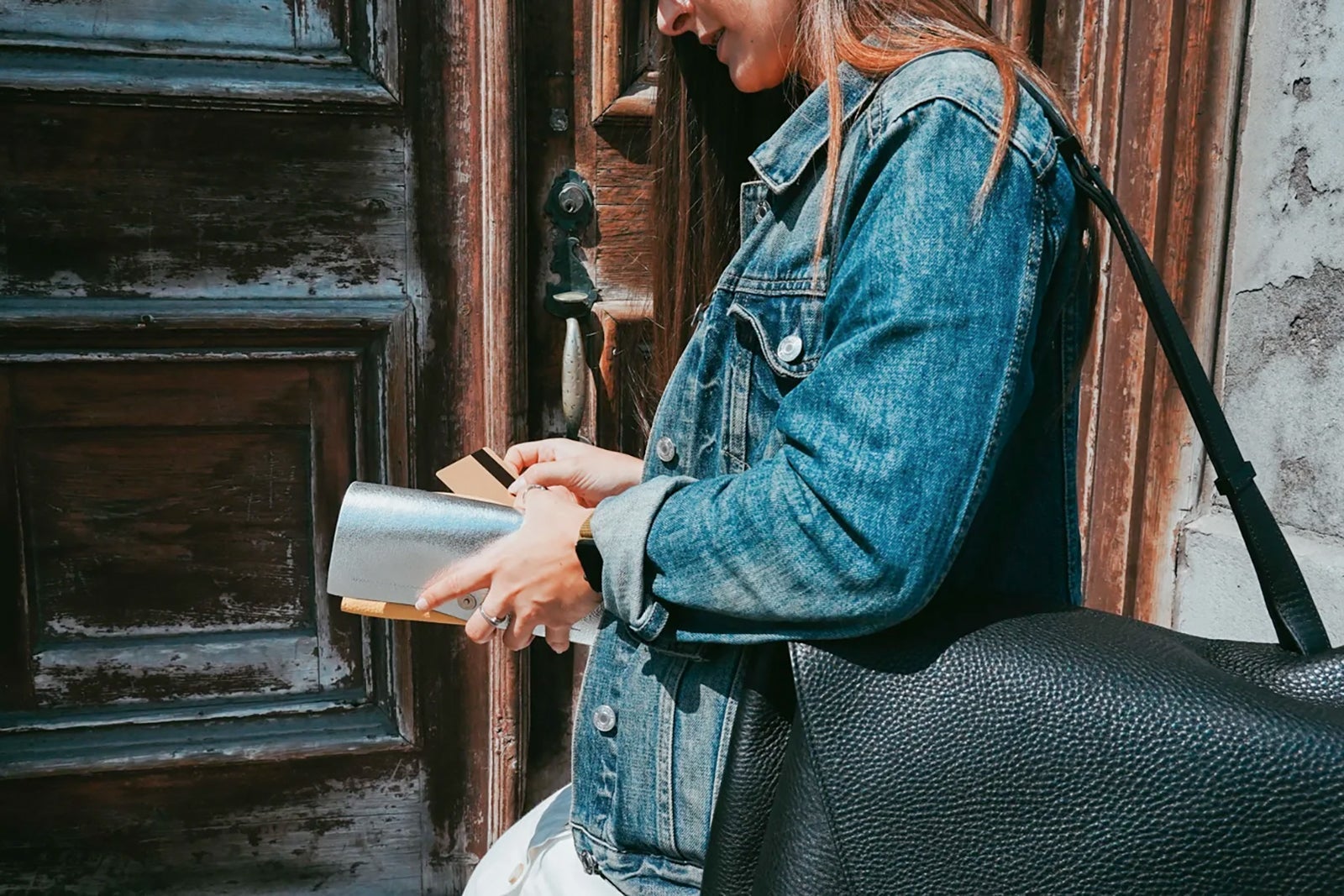 A person putting a credit card back in their wallet