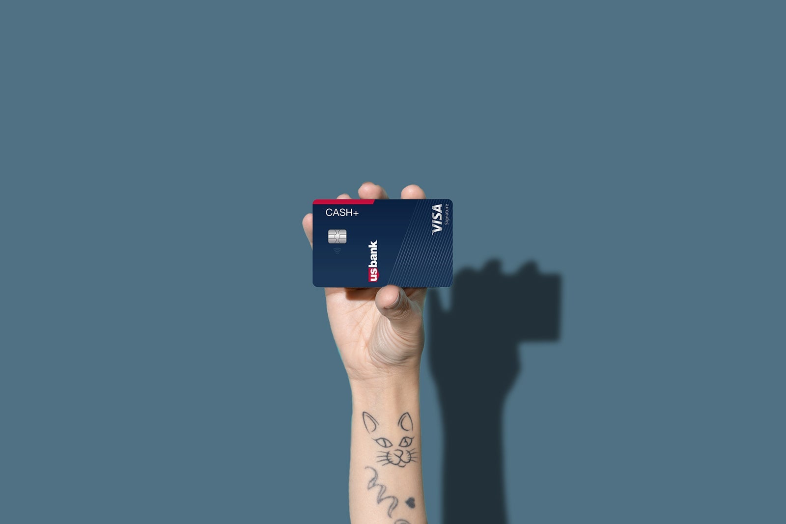 a hand holds a credit card