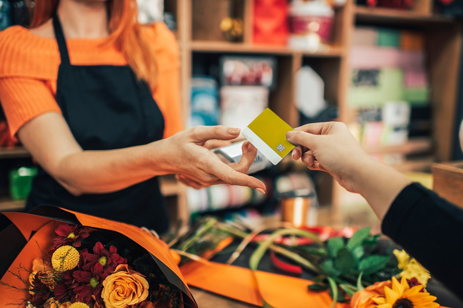 Person paying with a credit card at a shop