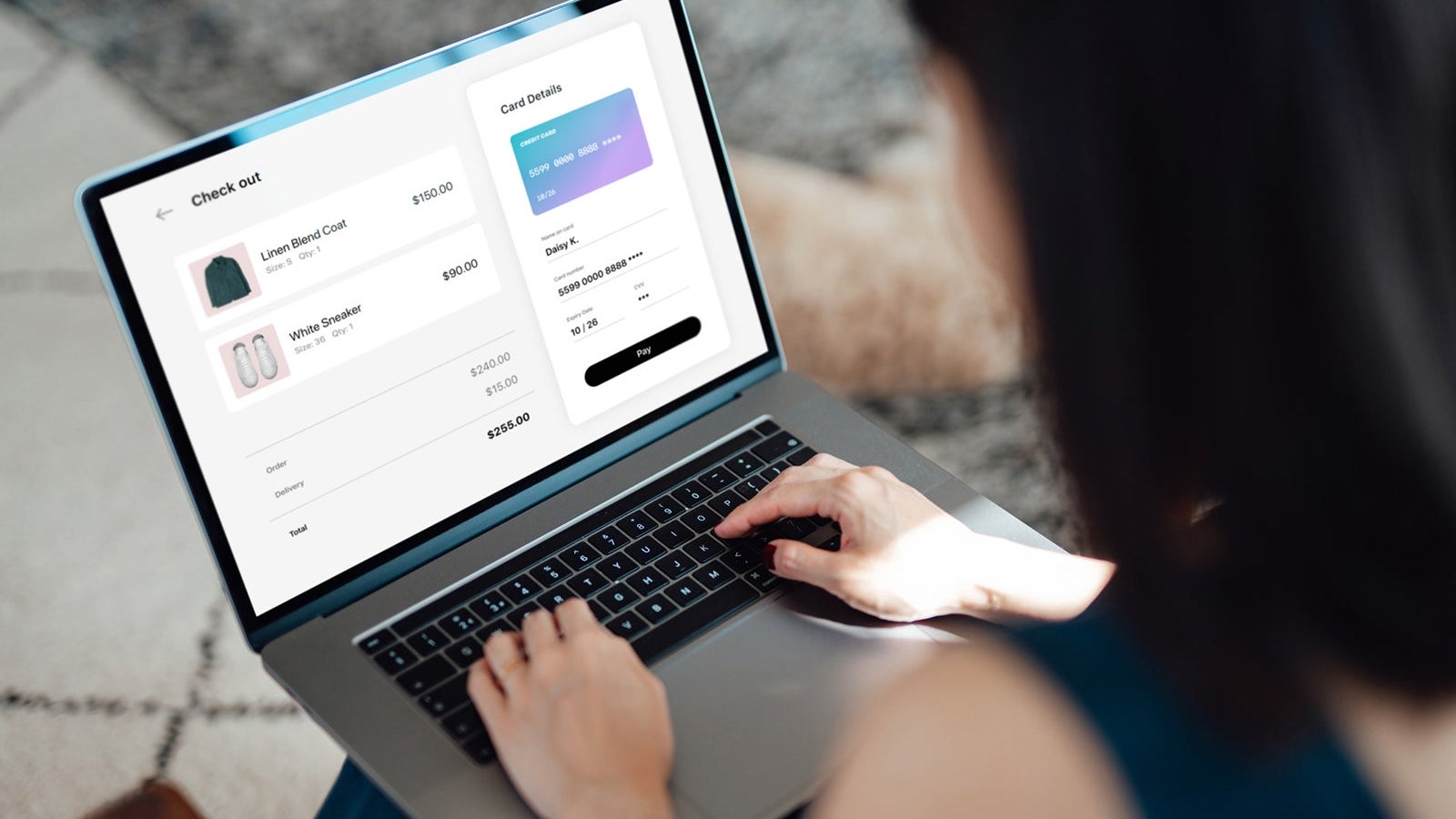 Woman shopping clothes online on laptop and making payment with credit card