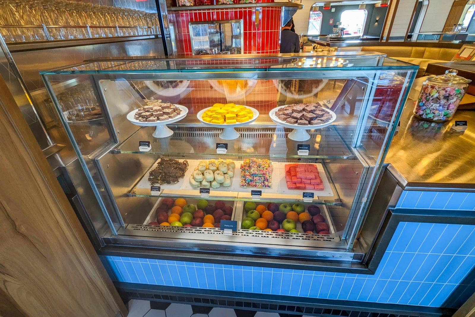 Glass case full of cake pops and macarons
