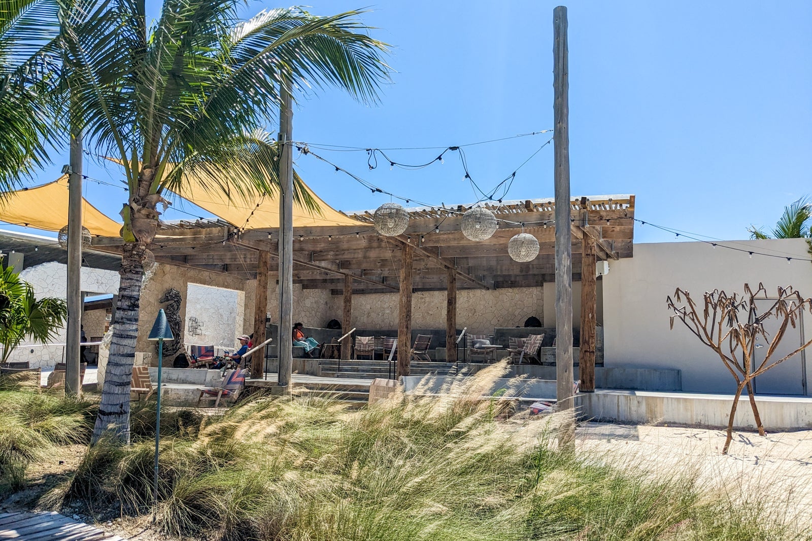 Thatched-roof, three-sided lounge on a beach