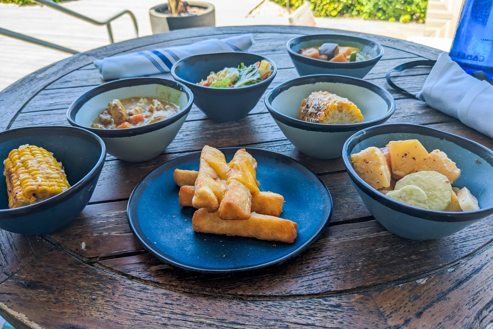 Table piled with blue dishes of food