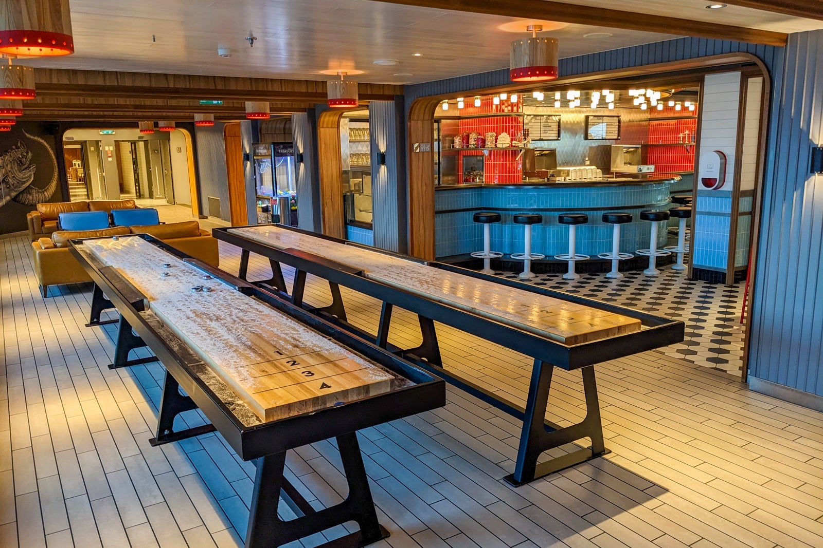 Table shuffleboard with a bar behind