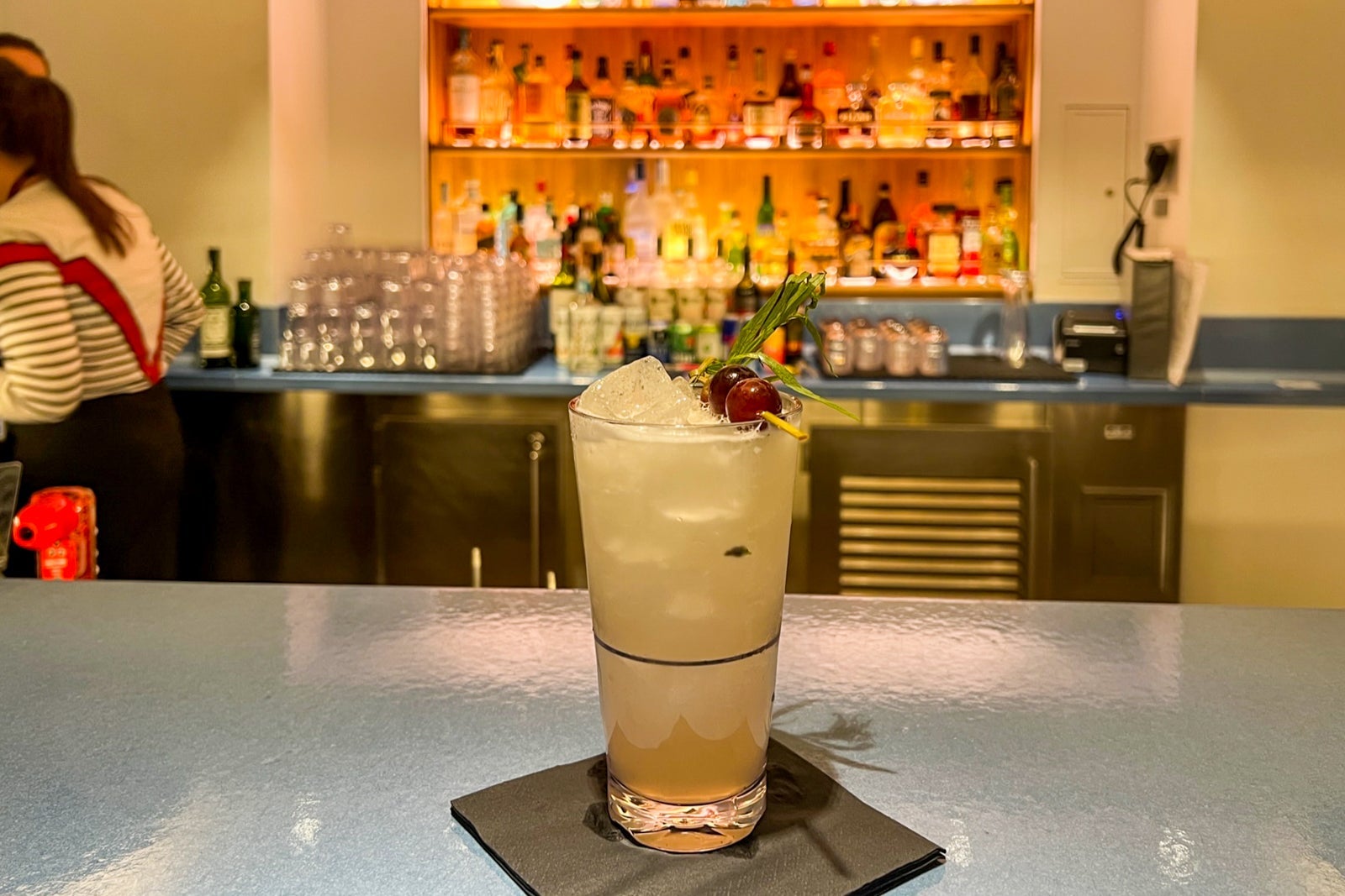 Cocktail with bar in the background