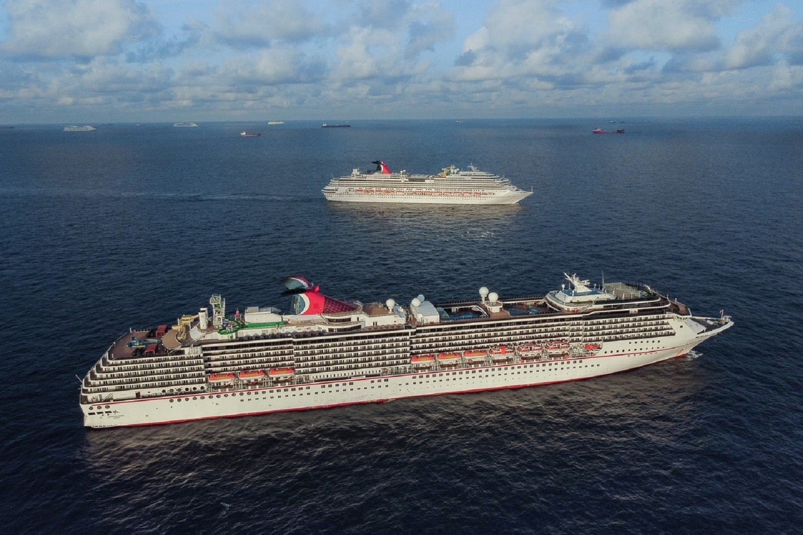 Two carnival ships anchored at sea