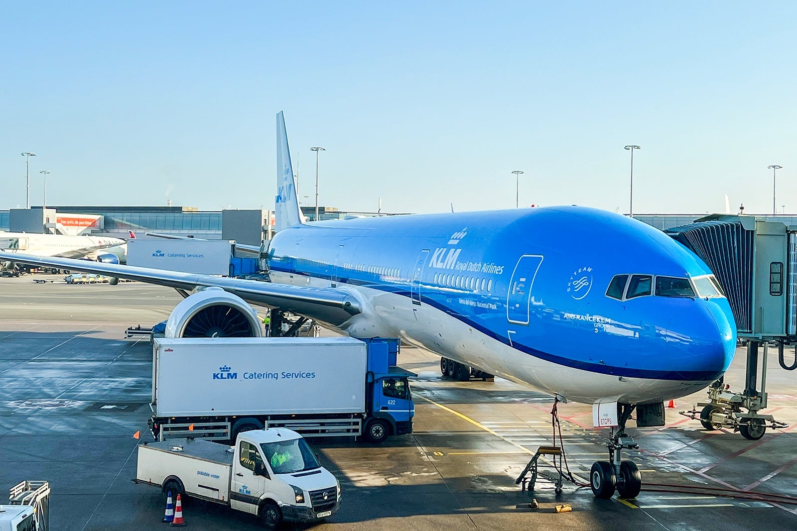 Blue KLM plane at gate with food truck