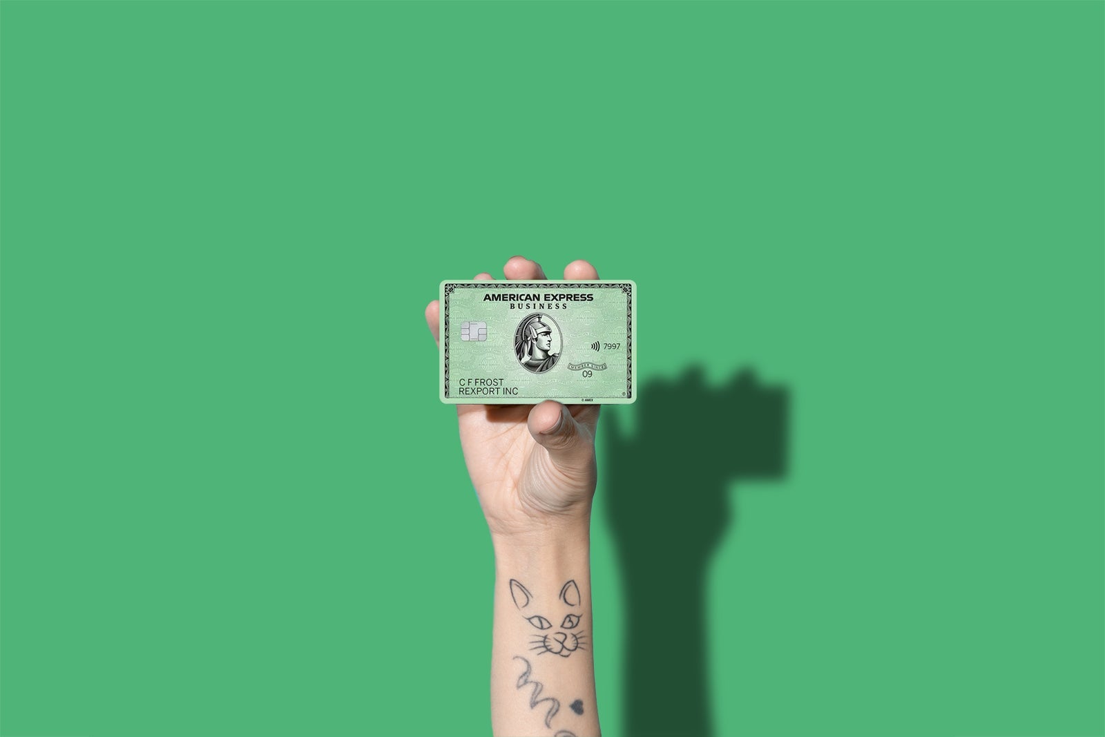 a hand holds a credit card