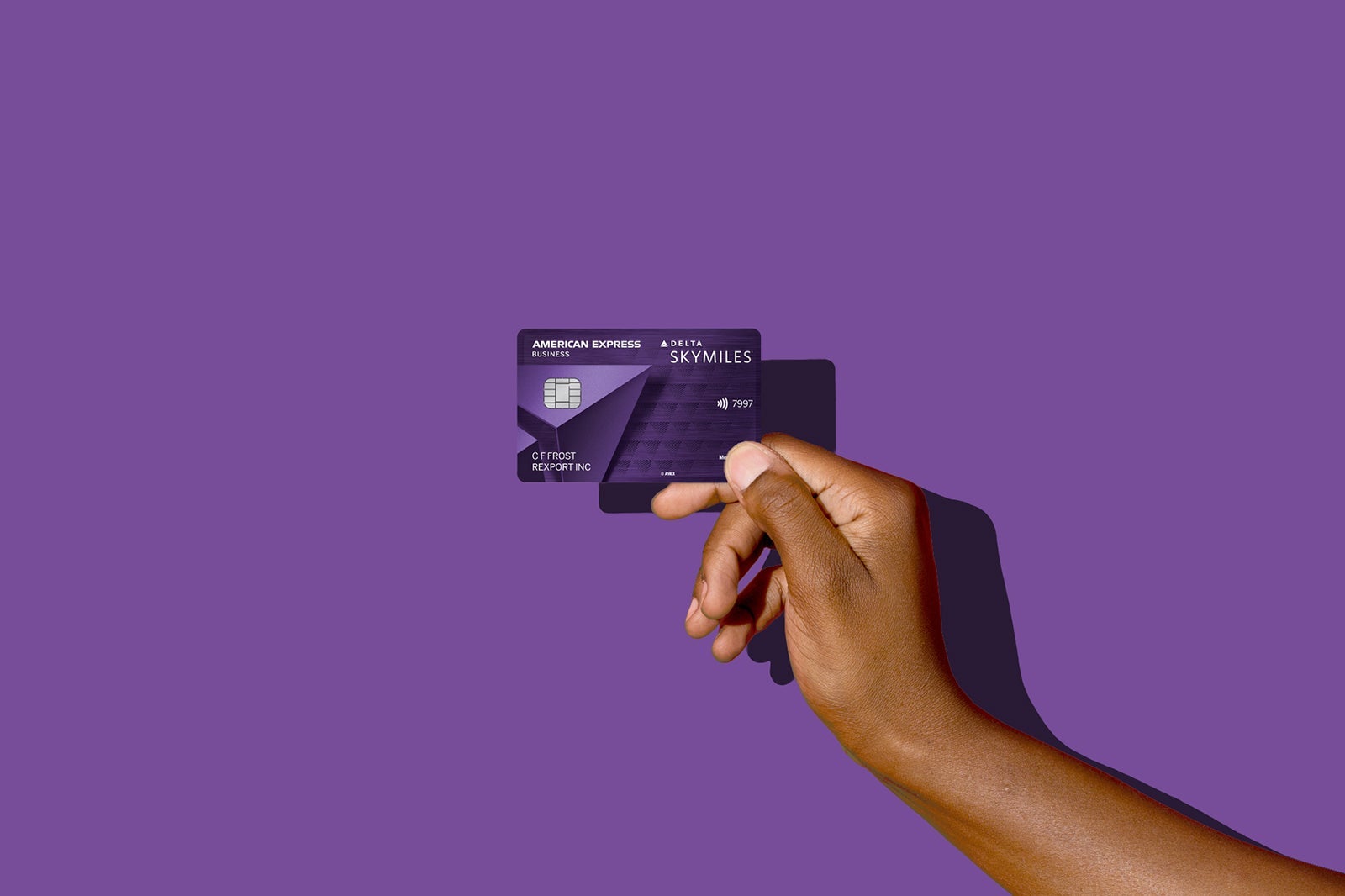 a hand holds a credit card